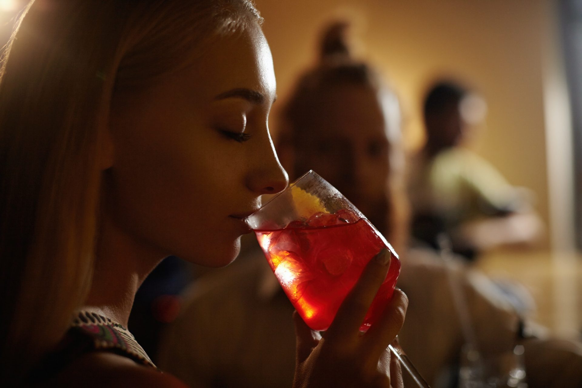 close-up-profile-of-glamorous-blonde-girl-enjoying-fresh-fruit-drink-sitting-at-bar-counter-next-to.jpg